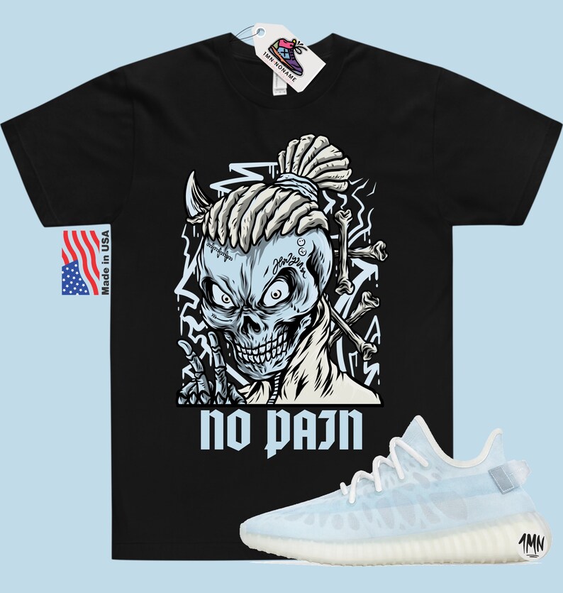 May include: Black t-shirt with a graphic of a skull with dreadlocks and the text "no pain". A pair of white and light blue sneakers are shown below the t-shirt.