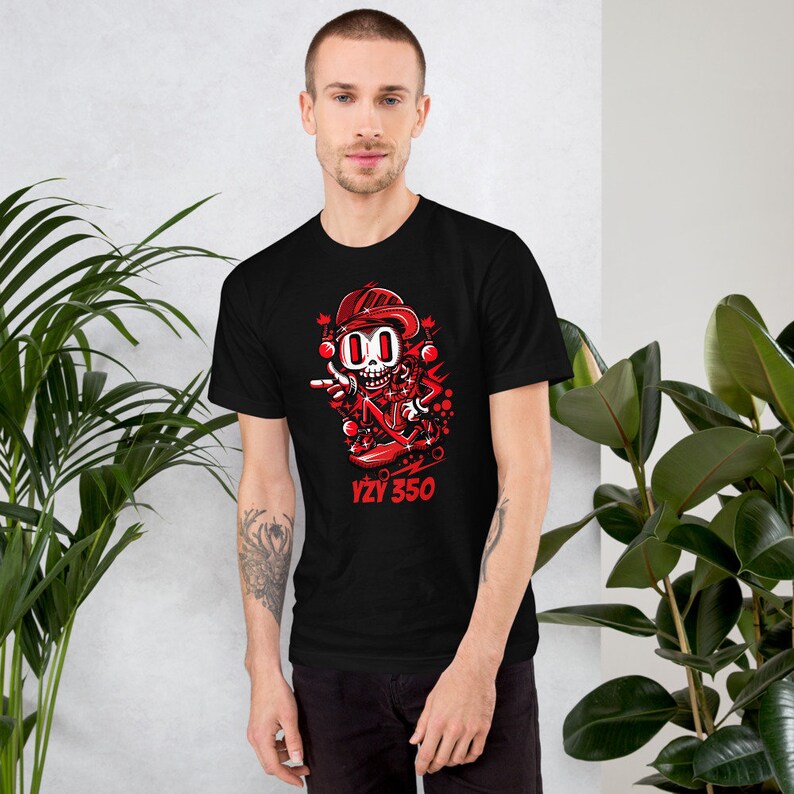 May include: Black t-shirt with a red cartoon character skateboarding and the text "YZY 350".