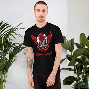 May include: Black t-shirt with a graphic of a scary clown with red hair and a white face. The text "FUNNY HOW?" is printed below the clown's face.
