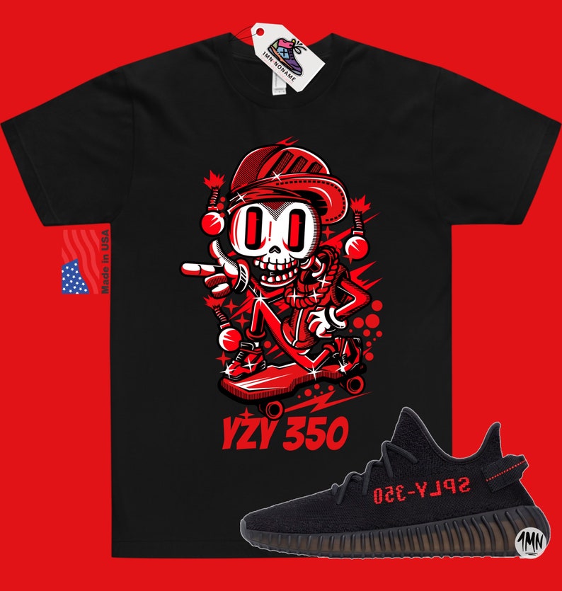 May include: Black t-shirt with a red cartoon character skateboarding and the text "YZY 350". A pair of black and red Yeezy 350 sneakers are shown below the t-shirt.