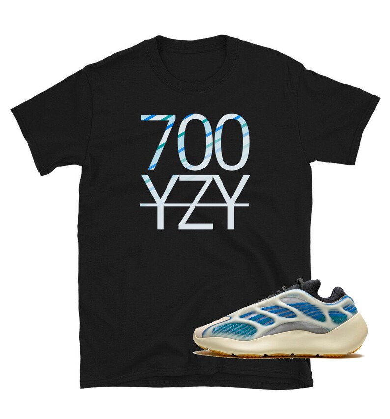 May include: Black t-shirt with white text that says "700 YZY" and a pair of white and blue sneakers with a black sole.