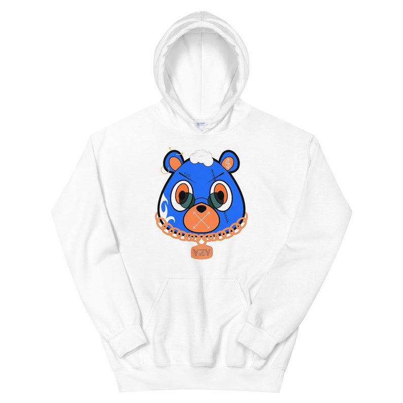 May include: White hoodie with a blue bear face graphic. The bear has a gold chain with a YZY pendant. The bear's eyes are orange and it has a stitched-up mouth.