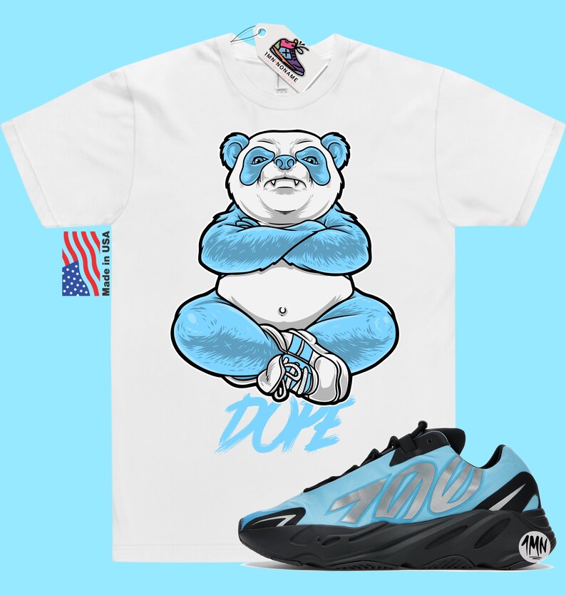 May include: White t-shirt featuring a blue panda illustration and the word "Dope" printed below. A pair of blue and black Adidas Yeezy 700 trainers are also shown.