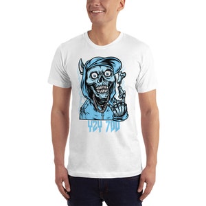 May include: White t-shirt with a blue graphic of a skull wearing a blue hoodie and hat. The skull is giving the middle finger and the text "424 700" is below the skull.