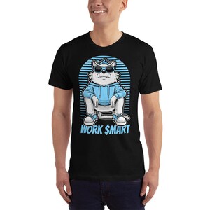 May include: Black t-shirt featuring a cartoon white cat wearing blue sunglasses and a blue hoodie. The cat is sitting with its legs crossed and has the text "WORK $MART" below it.