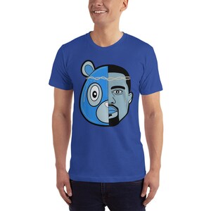 May include: A royal blue t-shirt with a graphic of a blue bear head with a crown and a man's face.