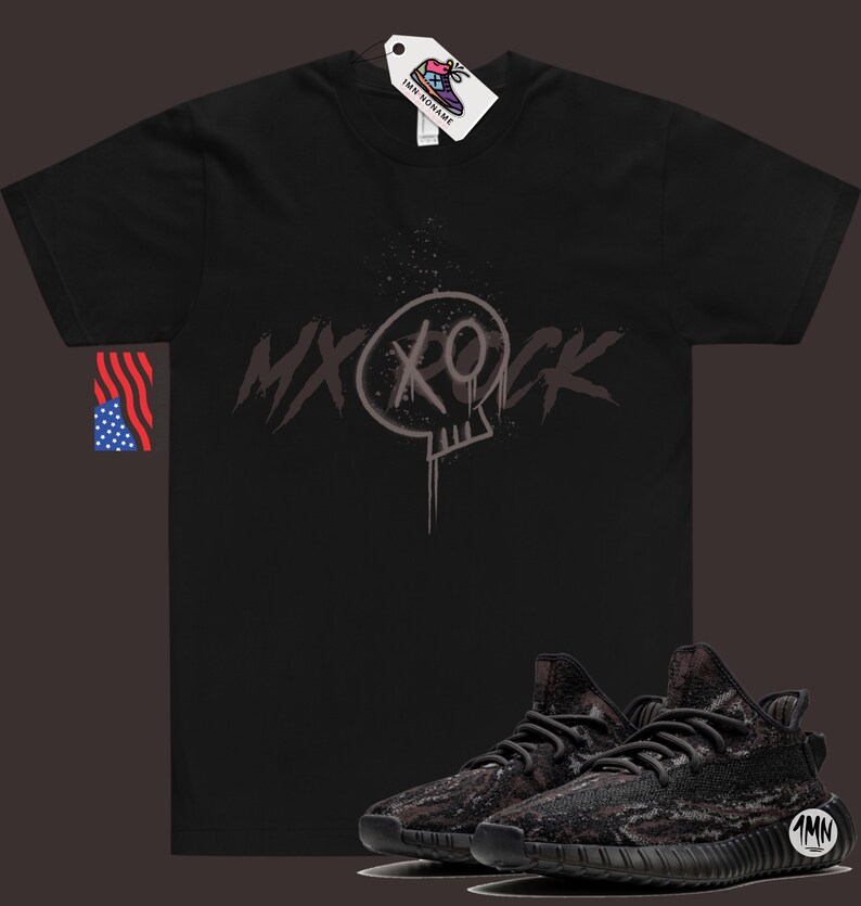May include: Black t-shirt with a skull graphic and the text "MXROCK" printed on the front. A pair of black and grey camouflage sneakers are also pictured.