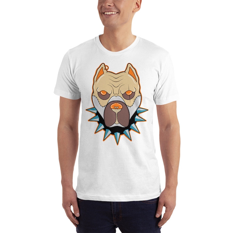 May include: White t-shirt with a graphic of a tan pit bull dog wearing a spiked collar. The dog has orange eyes and a blue nose.