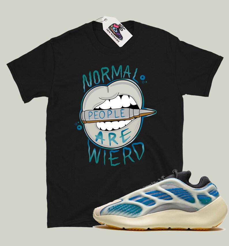 May include: Black t-shirt with a graphic of a mouth with a crayon that says "People are weird".  The t-shirt is paired with white and blue sneakers.
