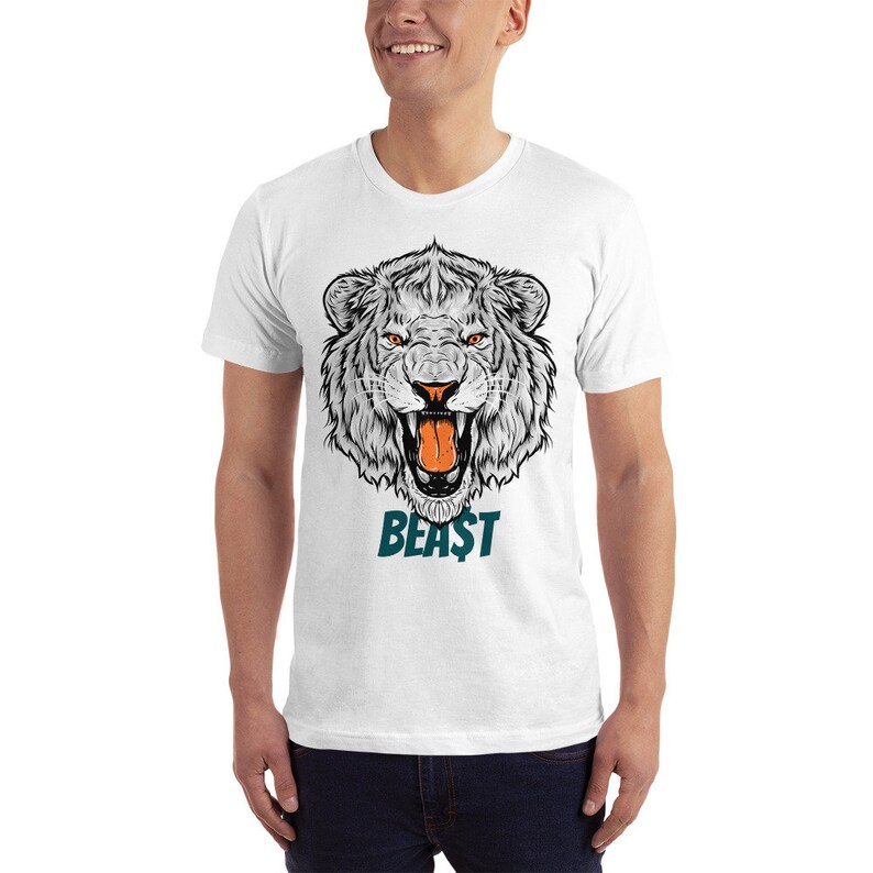 May include: White t-shirt featuring a graphic of a roaring white lion's head with the word "BEAST" in teal underneath.