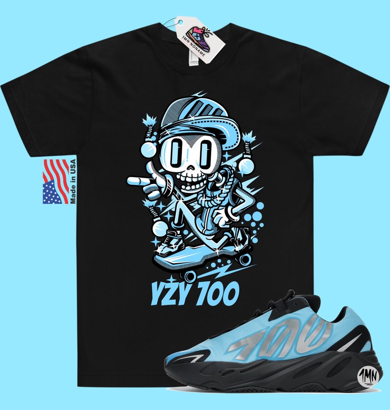 May include: Black t-shirt with a cartoon skeleton skateboarding graphic and the text "YZY 700".  A pair of light blue and black Yeezy 700 sneakers are also pictured.