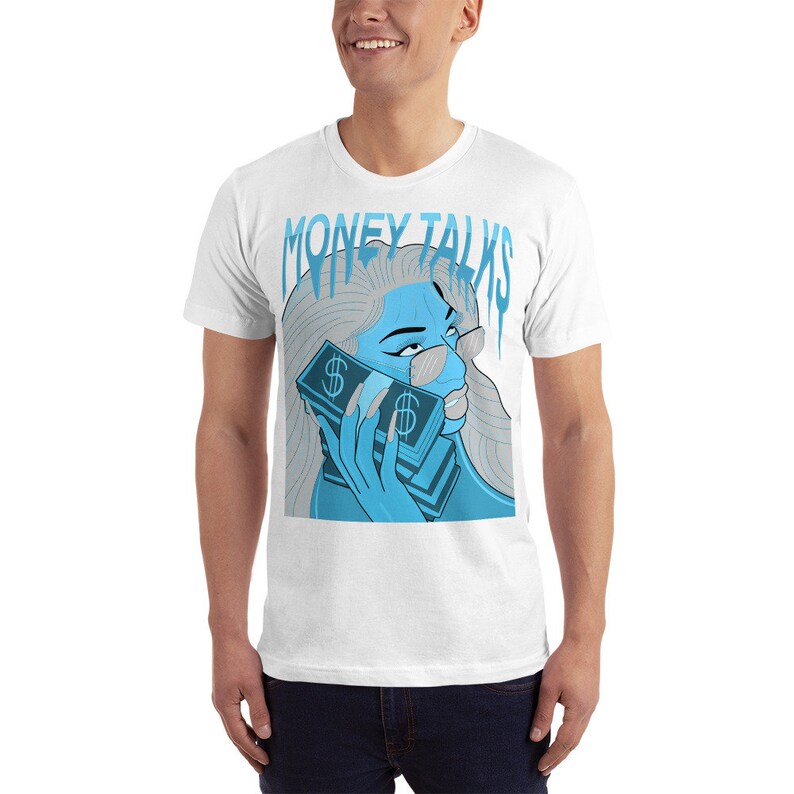 May include: White t-shirt with a blue graphic of a woman holding a stack of money to her ear. The text "MONEY TALKS" is above the woman's head.