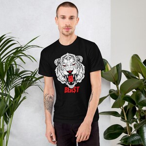 May include: Black t-shirt with a white graphic of a roaring white tiger with a red tongue. The text "BEAST" is printed in red below the tiger.