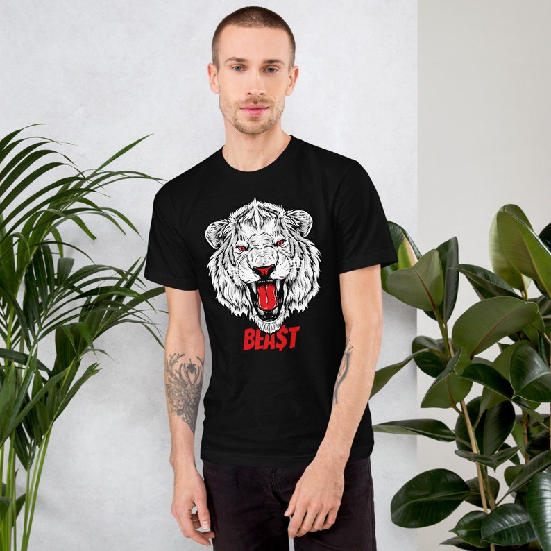 May include: Black t-shirt with a white graphic of a roaring white tiger with a red tongue. The text "BEAST" is printed in red below the tiger.