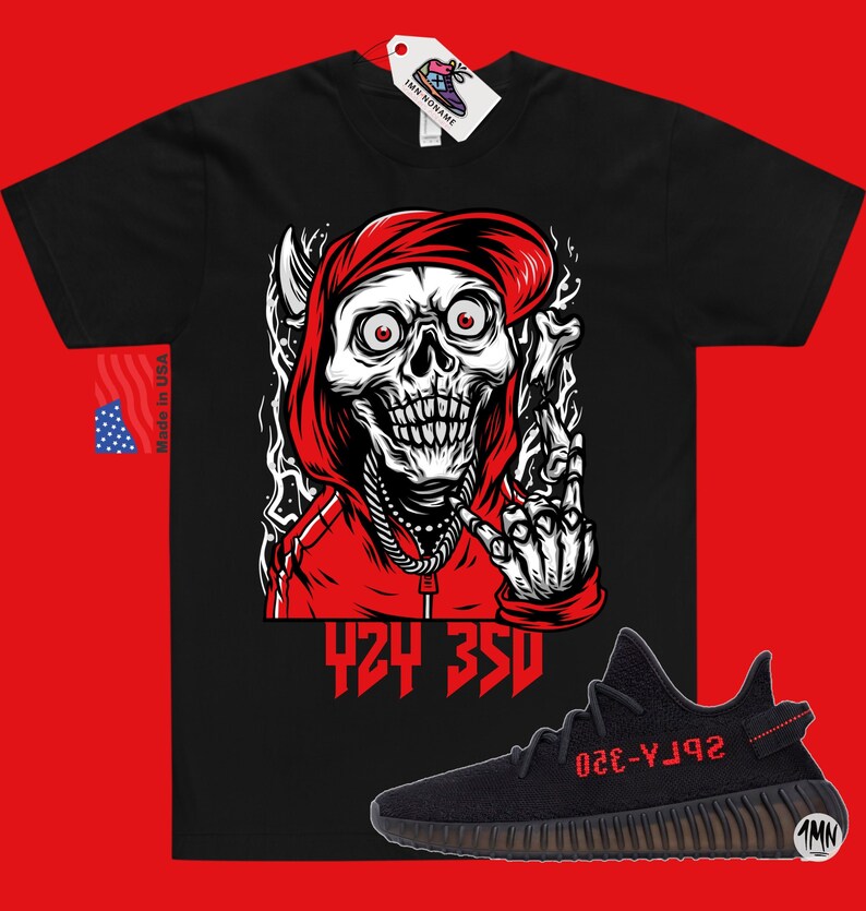 May include: Black t-shirt with a red skull wearing a red hoodie and making a middle finger gesture. The text "424 350" is printed below the skull. A pair of black and red Yeezy 350 Boost sneakers are shown below the t-shirt.