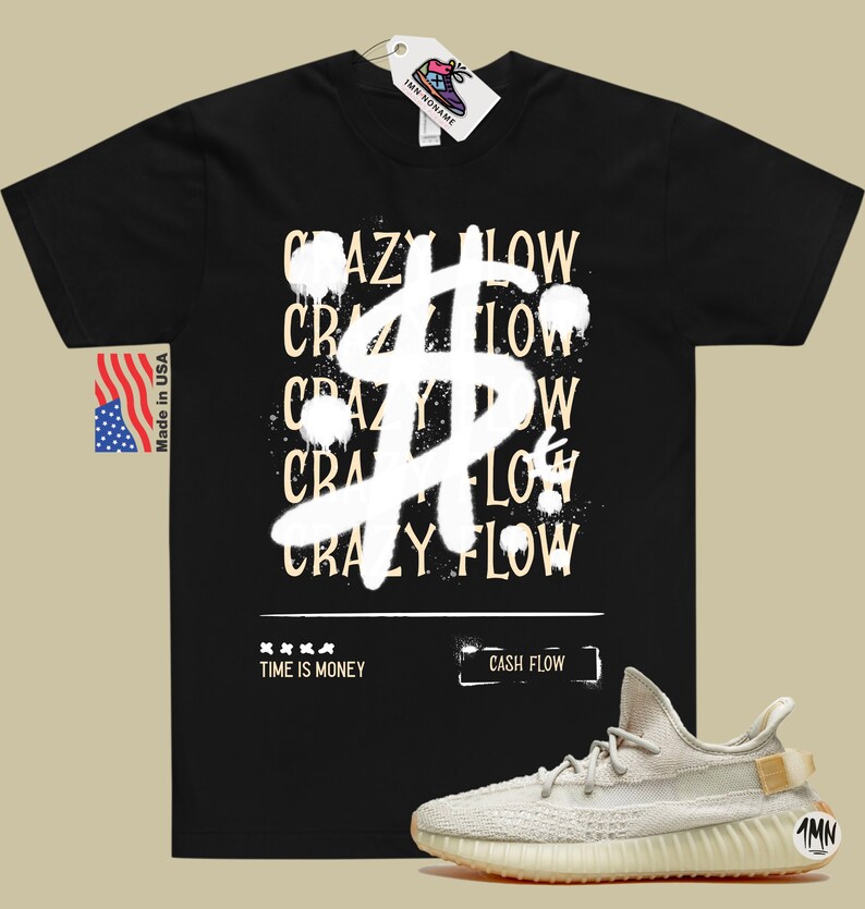 May include: Black t-shirt with a white dollar sign graphic and the text "CRAZY FLOW" repeated multiple times. The shirt also has the text "TIME IS MONEY" and "CASH FLOW". A pair of light beige sneakers with a brown sole are shown below the shirt.