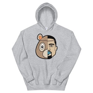 May include: A grey hoodie featuring a graphic of a bear and a man's face split in half. The bear is wearing a crown of thorns.