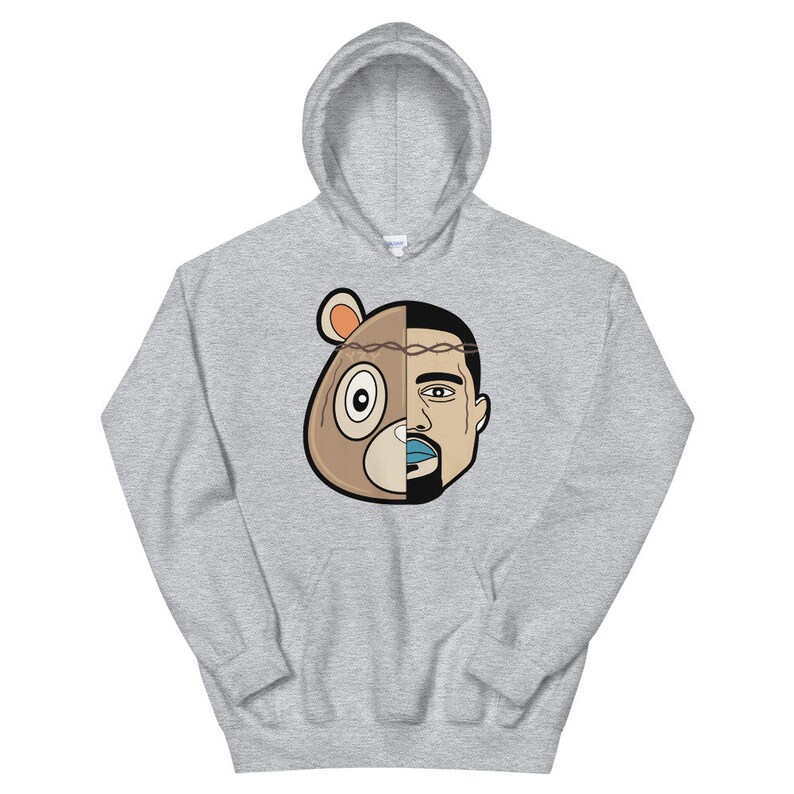 May include: A grey hoodie featuring a graphic of a bear and a man's face split in half. The bear is wearing a crown of thorns.