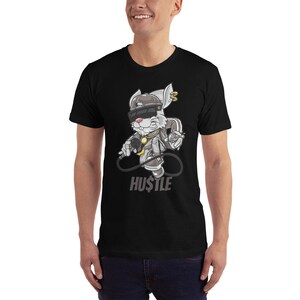 May include: Black t-shirt with a cartoon rabbit wearing a hat, sunglasses, and a gold chain. The rabbit is holding a microphone and a spray can. The text "HUSTLE" is printed below the rabbit.