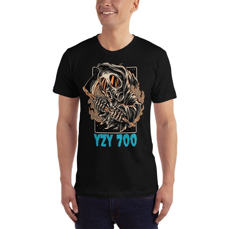 May include: Black t-shirt with a graphic of a skeleton wearing a gas mask and holding a scythe. The text "YZY 700" is printed below the graphic.