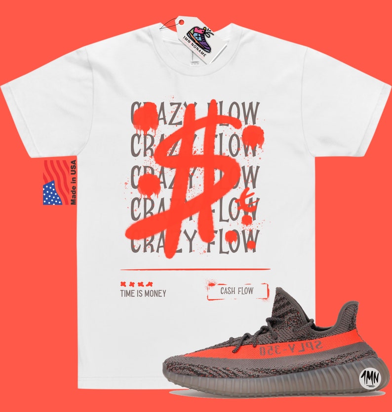 May include: White t-shirt featuring a red spray paint design of a dollar sign and the repeated words "Crazy Flow". The shirt also has the text "Time is Money" and "Cash Flow". A pair of grey and orange trainers are shown below the shirt.
