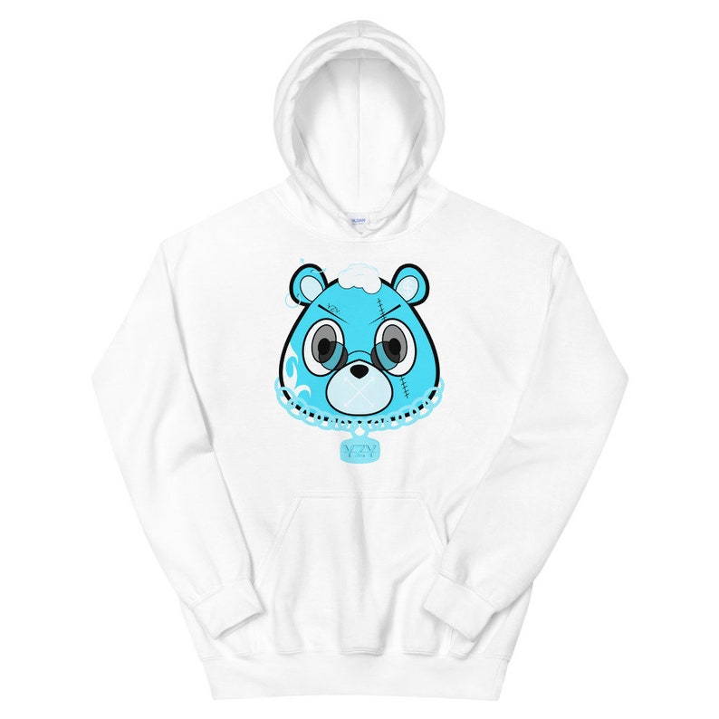 May include: White hoodie with a blue cartoon bear face wearing a chain with a pendant. The bear has stitches on its face and a cloud on its head.