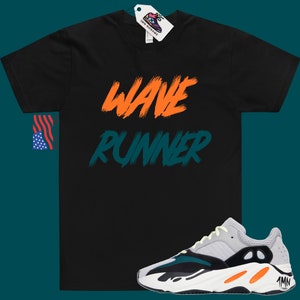 May include: Black t-shirt with "WAVE RUNNER" written in orange and teal on the front. A pair of grey, black, and white sneakers with orange accents.