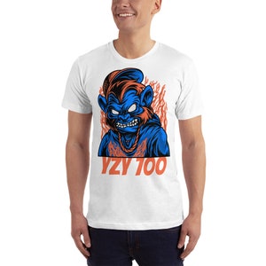 May include: White t-shirt with a blue and orange cartoon character with flames behind it. The text "YZY 100" is printed below the character.