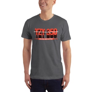 May include: A dark gray t-shirt with a red and black graphic that says "YZY 350" with a white line through it. The text "BELUGA REFLECTIVE" is below the graphic.
