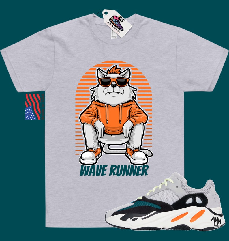May include: A grey t-shirt with a cartoon cat wearing sunglasses and an orange hoodie. The cat is sitting on a striped background with the text "Wave Runner" below it. A pair of white, green, and orange sneakers are shown below the t-shirt.