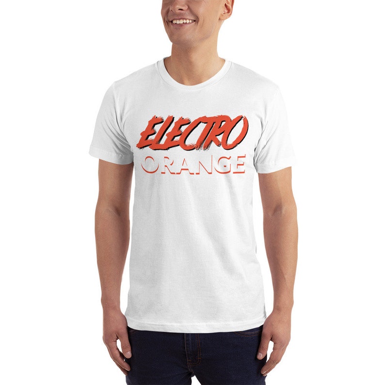 May include: White t-shirt with a red graphic that says "ELECTRO ORANGE" in a stylised font.