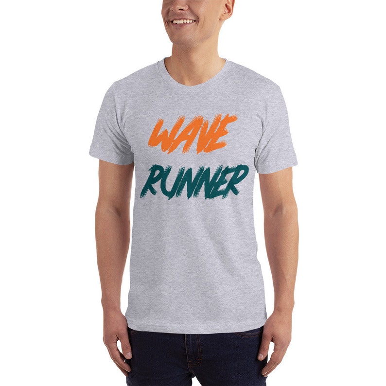 May include: A heather grey t-shirt with the words "WAVE RUNNER" printed in orange and teal.