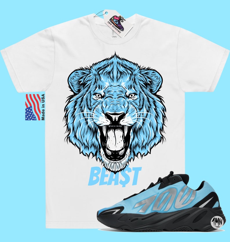 May include: White t-shirt with a blue lion graphic and the word "BEAST" printed below. A pair of blue and black sneakers with the number "700" printed on the side.