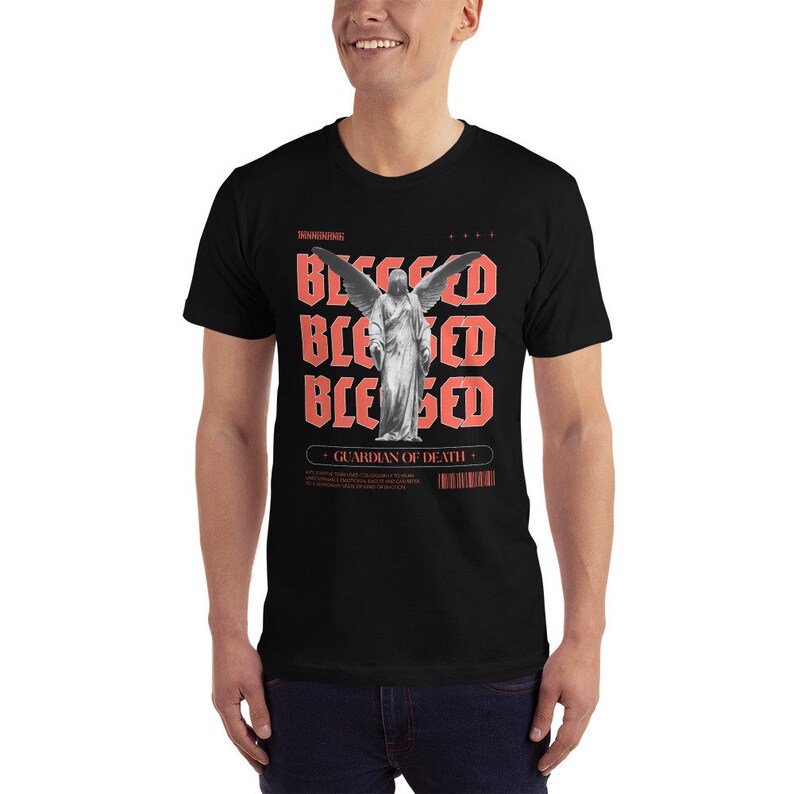 May include: Black t-shirt with a graphic print of an angel with wings and the word "Blessed" repeated four times in red. The text "Guardian of Death" is also printed in red below the angel.