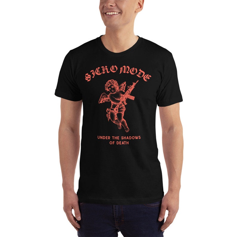 May include: Black t-shirt with a red graphic of a cherub holding a rifle. The text "Sicko Mode" and "Under the Shadows of Death" is printed in red.