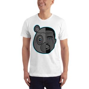 Op de afbeelding: Wit T-shirt met een afbeelding van een zwart en grijs berenhoofd met een menselijk gezicht aan de rechterkant. Het oog van de beer is blauw en het oog van de mens is blauw. Het menselijke gezicht heeft een baard en de tekst "YZY" staat op het voorhoofd.