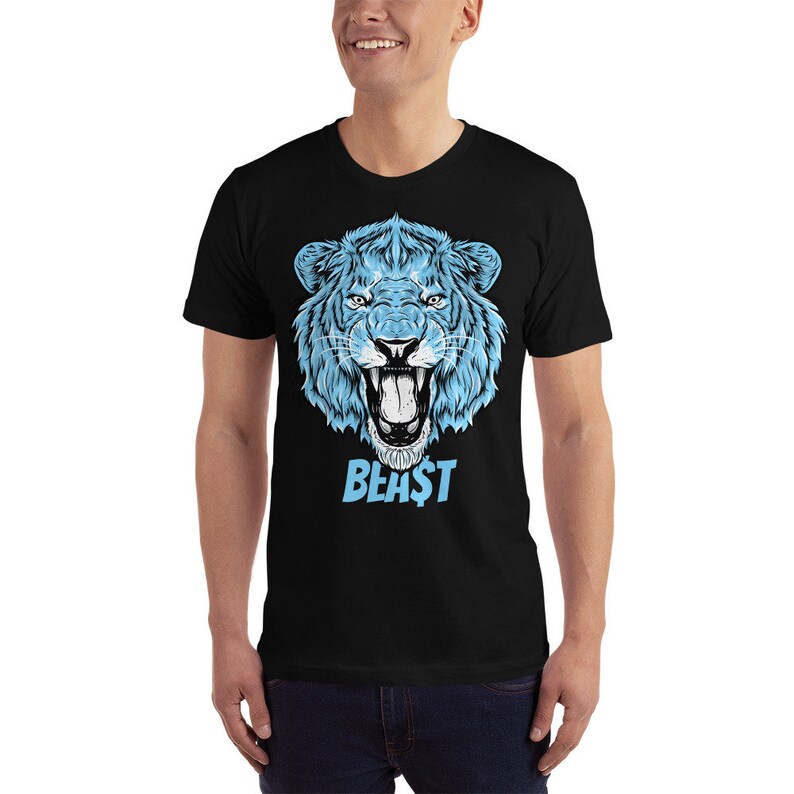 May include: A black t-shirt with a blue lion's head graphic and the word "BEAST" printed in blue below it.