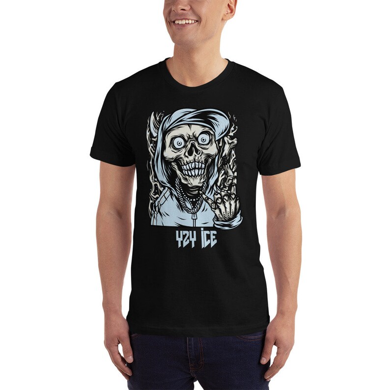 May include: Black t-shirt with a graphic of a cartoon skull wearing a blue hoodie and making a hand gesture. The text "424 ICE" is printed below the graphic.