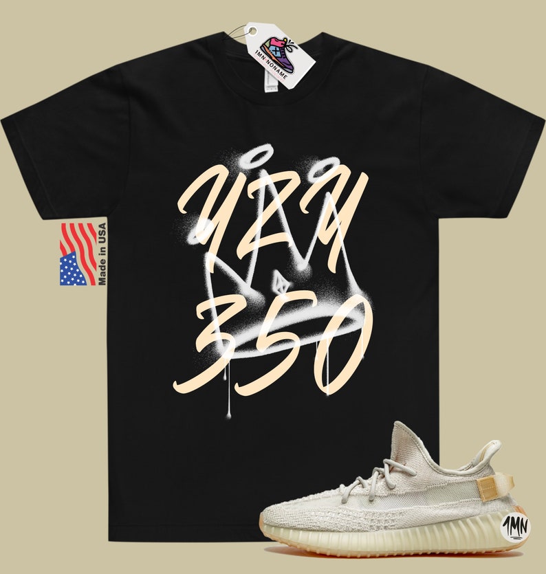 May include: A black t-shirt with a white and tan graphic of a crown with the text "YZY 350" on it. A pair of tan sneakers with a white sole and a tan tag with the text "1MN" on it.