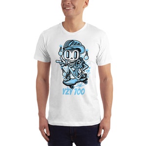 May include: White t-shirt with a blue cartoon skeleton wearing a blue hat and sunglasses, riding a skateboard with the text "YZY 700" underneath.