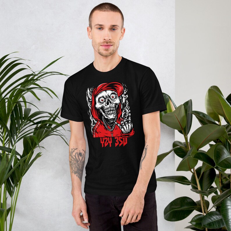 May include: Black t-shirt with a graphic of a skull wearing a red hoodie and giving the middle finger. The text "424 350" is printed below the skull.