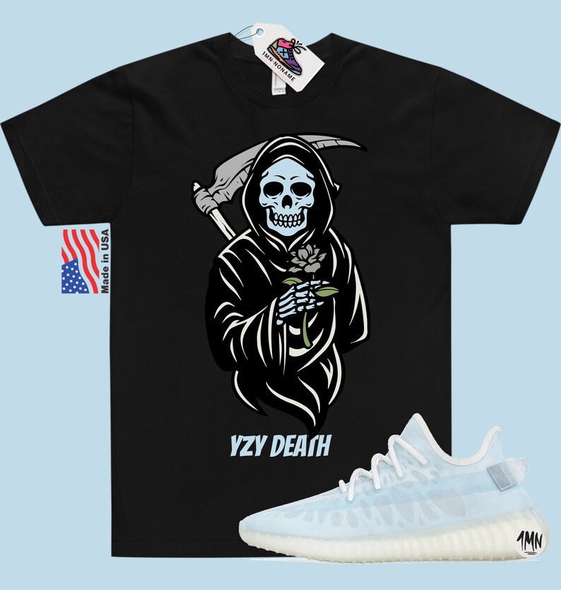 May include: Black t-shirt featuring a graphic of the Grim Reaper holding a flower. The text "YZY DEATH" is printed below the graphic. A pair of white and light blue trainers are shown below the t-shirt.