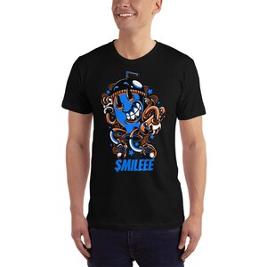 May include: Black t-shirt featuring a blue cartoon character holding a straw and a cup. The character has a big smile and the text "$MILEEE" is printed below it.
