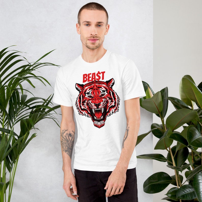 May include: White t-shirt with a red tiger graphic and the word "BEAST" in red letters.