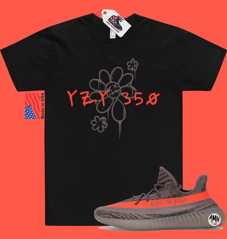 May include: Black t-shirt with a gray flower graphic and the text "YZY 350" in red. A pair of gray and orange Yeezy 350 sneakers are shown below the t-shirt.