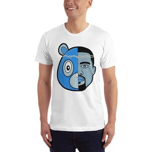 May include: White t-shirt with a blue and gray illustration of a bear head and a man's face. The bear's face is on the left side of the image and the man's face is on the right side of the image. The bear has a blue nose and a black eye. The man has a black beard and a black eye. The bear and man's faces are separated by a line.