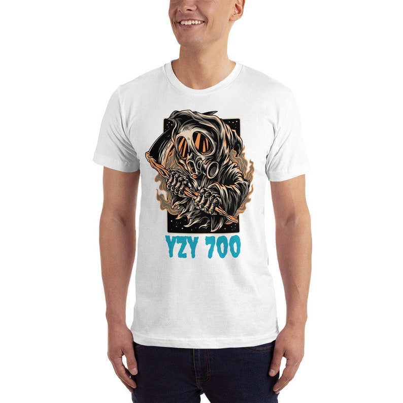 May include: White t-shirt with a graphic of a skeleton wearing a gas mask and holding a scythe. The text "YZY 700" is printed below the graphic.