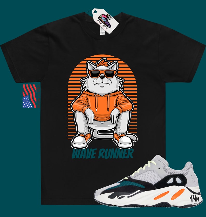 May include: Black t-shirt with a cartoon cat wearing sunglasses and an orange hoodie. The cat is sitting on a striped background with the text "Wave Runner". A pair of white, grey, green, and orange sneakers are shown below the t-shirt.