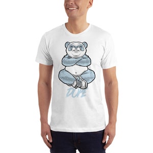 May include: White t-shirt featuring a blue panda bear sitting with its arms crossed and the word "DUPE" printed below.