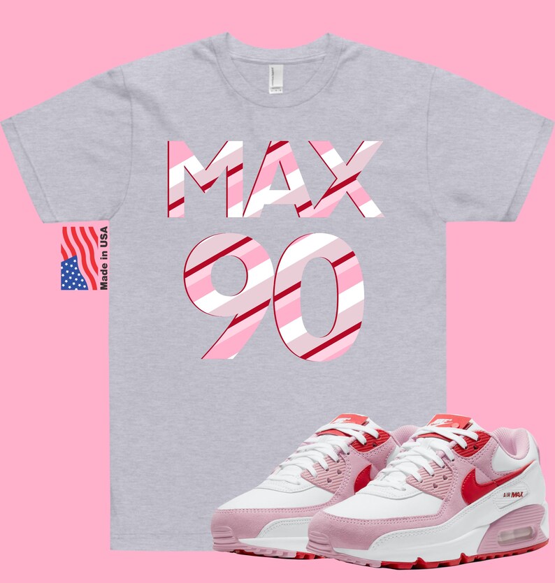 May include: Gray t-shirt with the words "MAX 90" in pink and red stripes.  Pink and white sneakers with red accents and a white Nike swoosh.